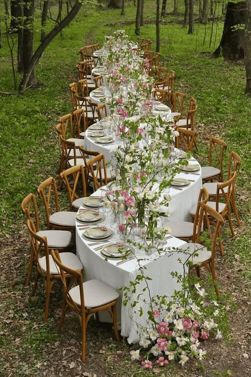 Woodland wedding table surrounded by wildflowers and forest scenery
