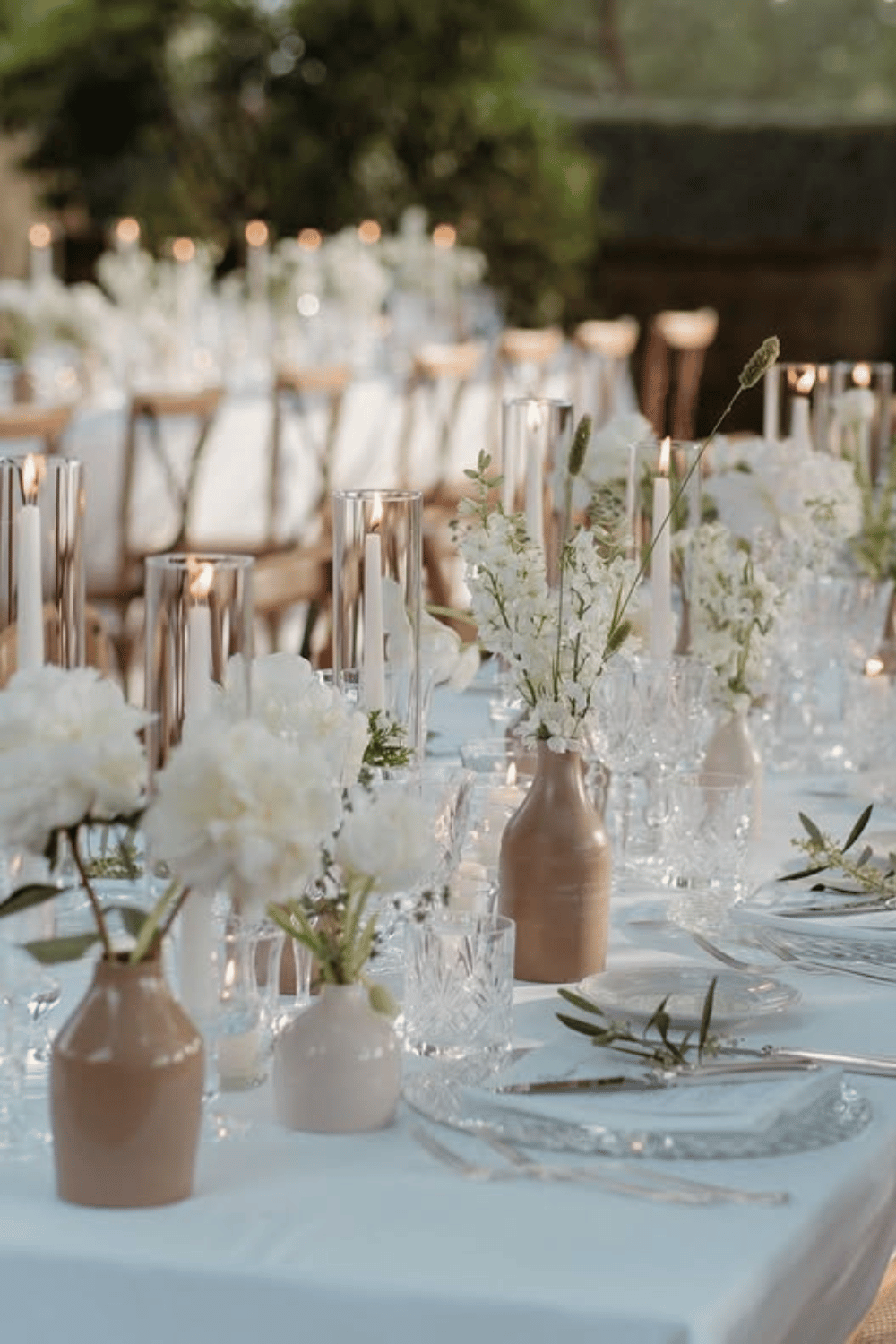 Neutral-toned tablescape with ceramic bud vases and minimalist styling