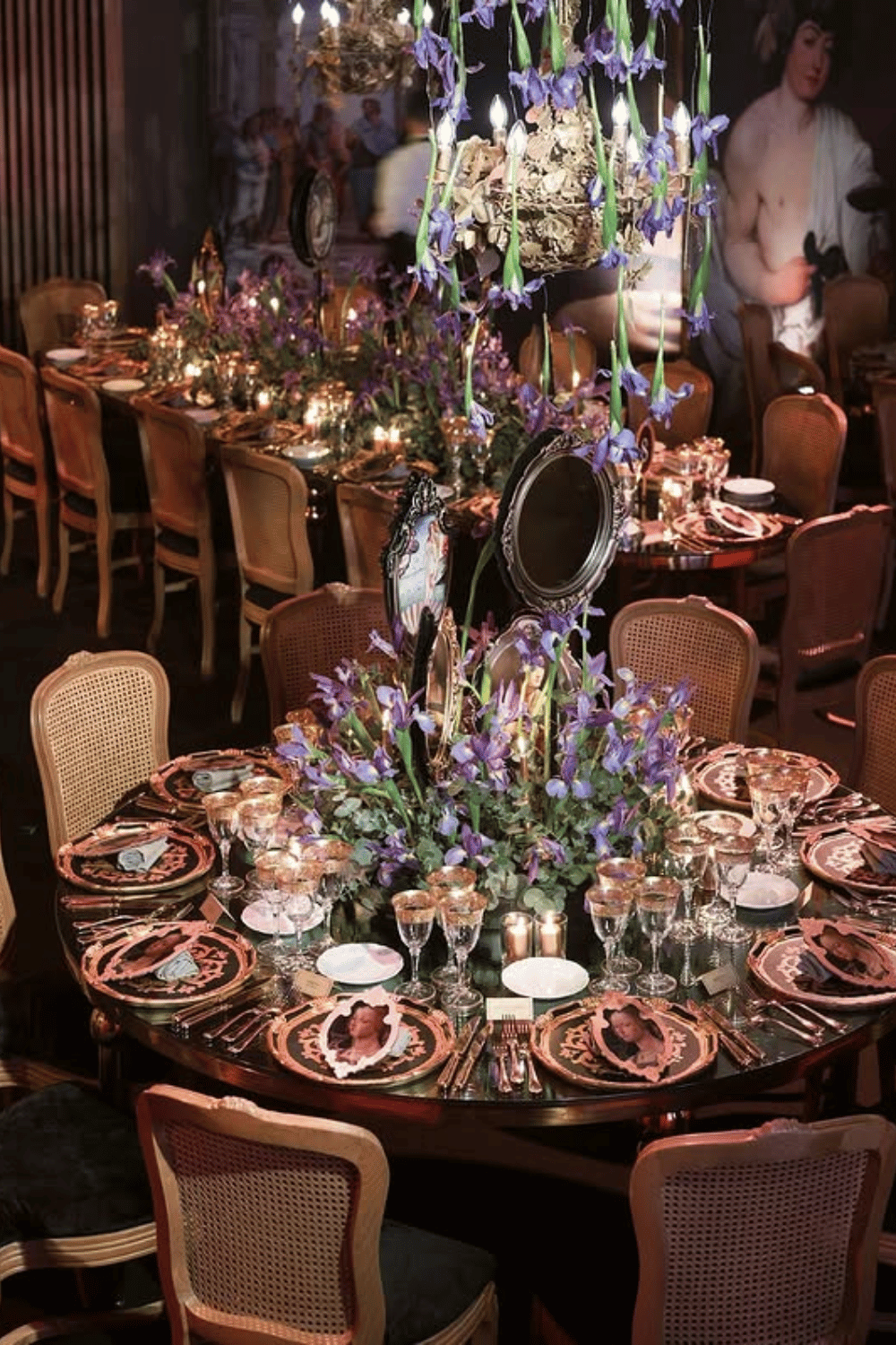 Moody wedding table with deep florals and baroque-inspired plates in a dramatic setting