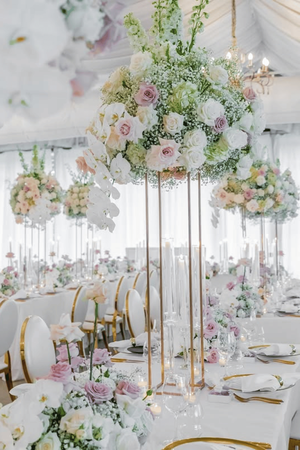 Tall floral centerpieces with gold stands at a luxury wedding reception. Wedding Table Decorations