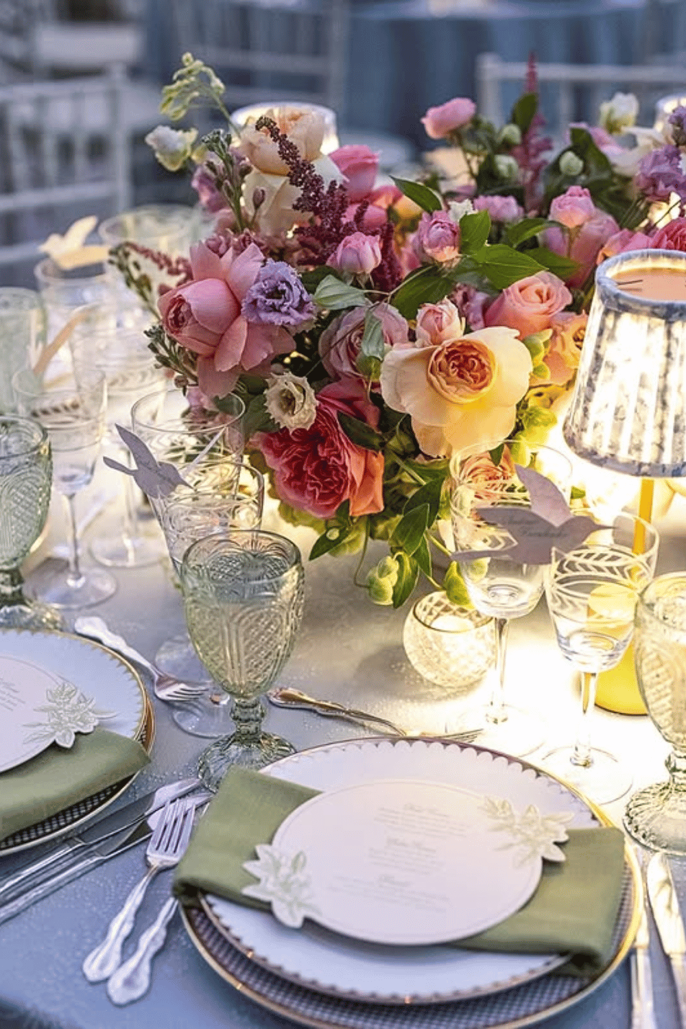 Butterfly-themed wedding table with layered plates and soft lamp lighting Wedding Table Inspiration