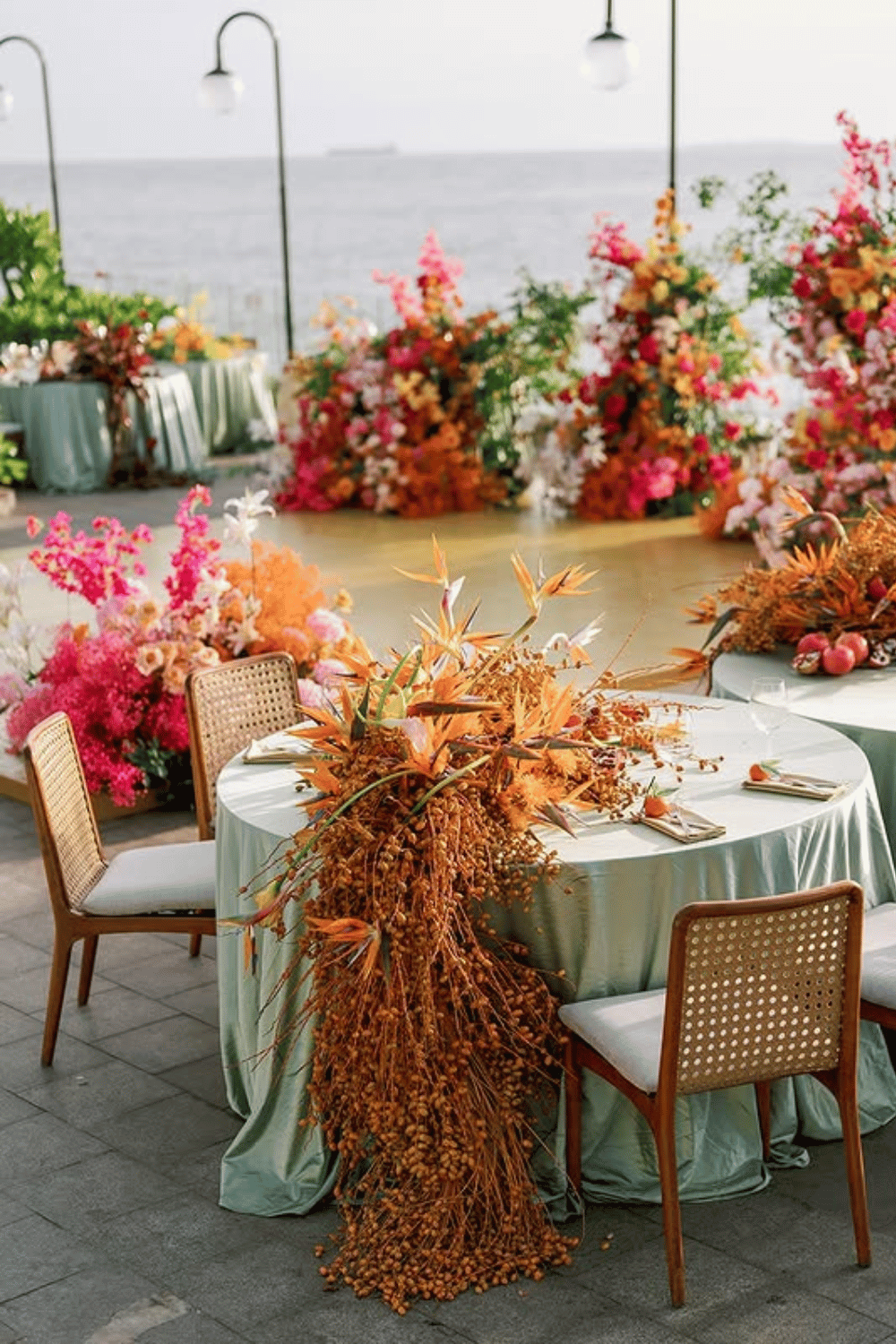 Tropical coastal wedding table with vibrant floral arrangements and turquoise tablecloths. Wedding Table Inspiration