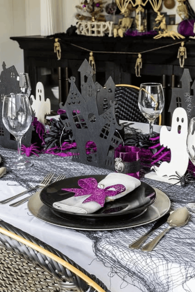 Haunted house cutout decorations on a Halloween table