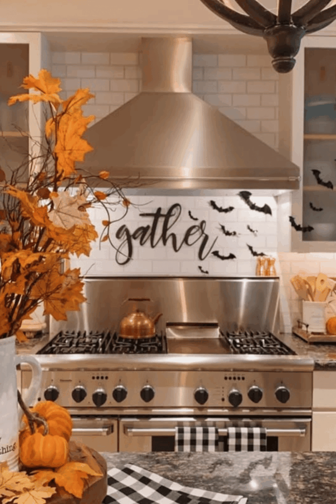 Fall kitchen stove decorated with gather sign, black bats, pumpkins, and autumn leaves