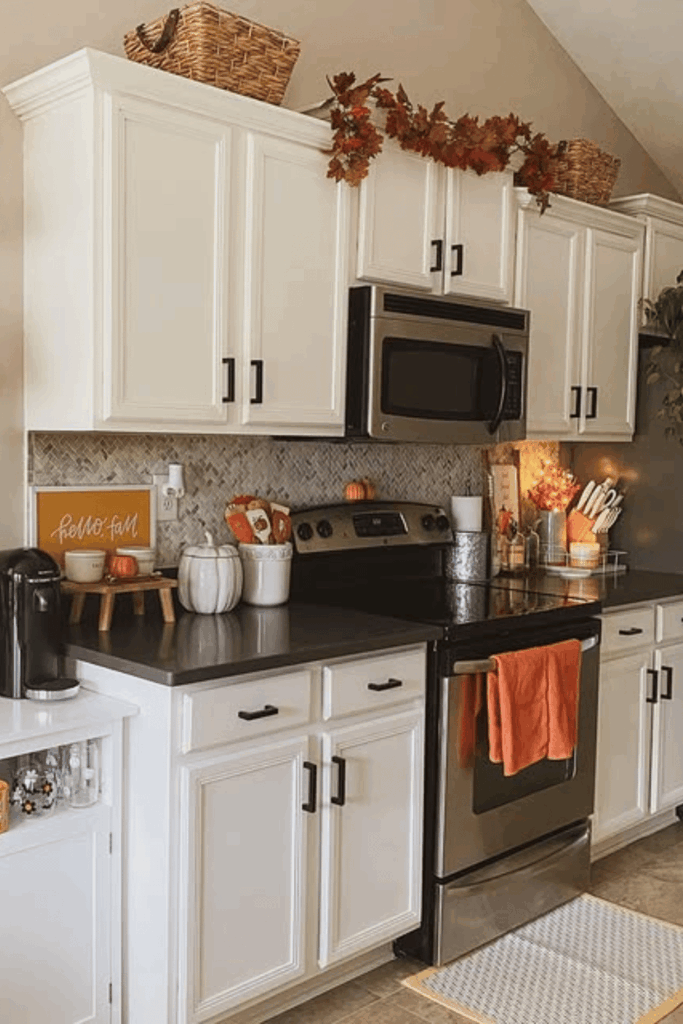 Open kitchen shelves decorated with baskets, mugs, and faux pumpkins for fall