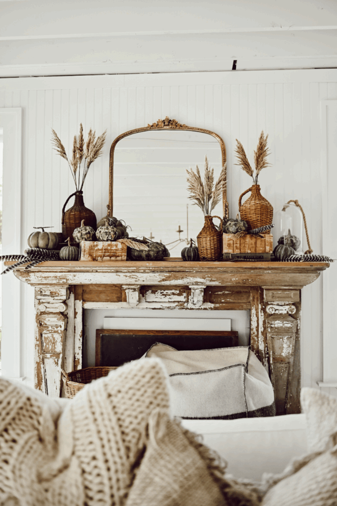 Forged rustic fall mantel decor with wood tones and greenery