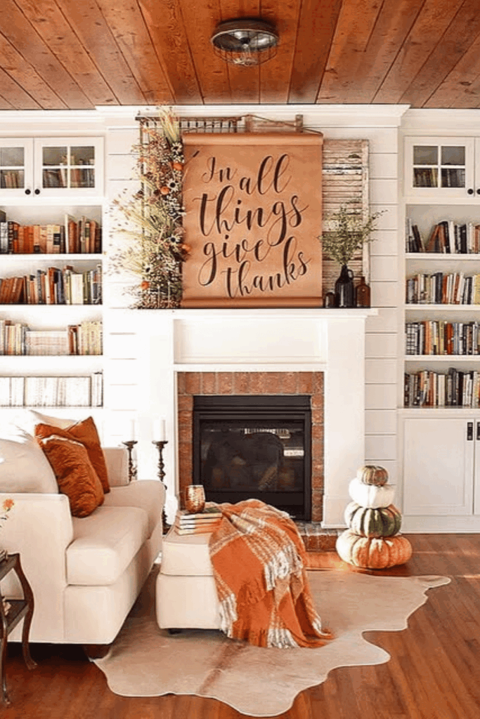 Fall florals arranged on one side of the mantel with candles