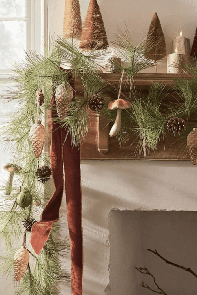Miniature pine trees styled with fall mantel decor for late season