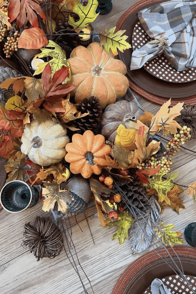 Autumn centerpiece with leaves, pinecones, and pumpkins