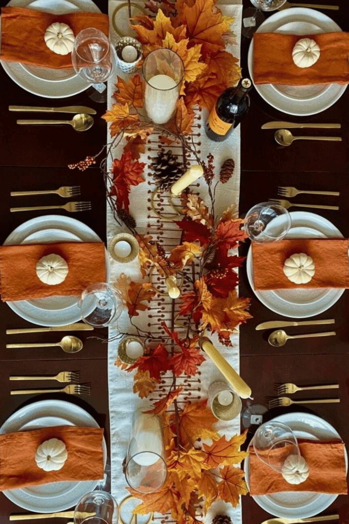 Orange napkins with mini white pumpkins for autumn dining 