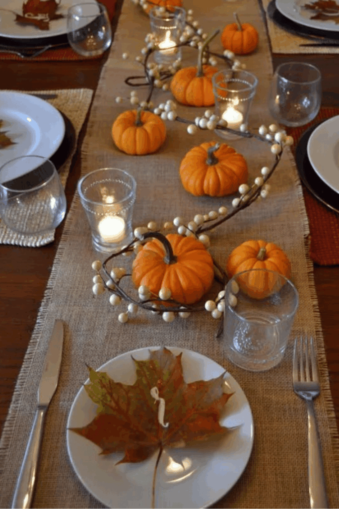 Burlap runner with mini pumpkins and tea light candles 