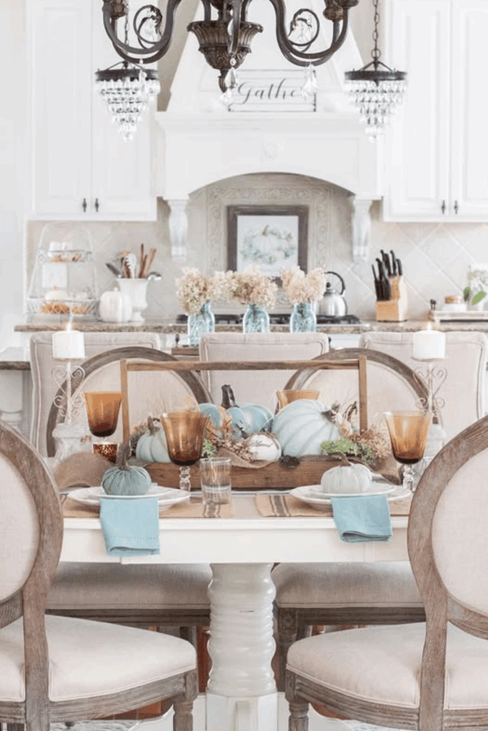 Soft blue pumpkins with copper mugs and neutral fall table setting