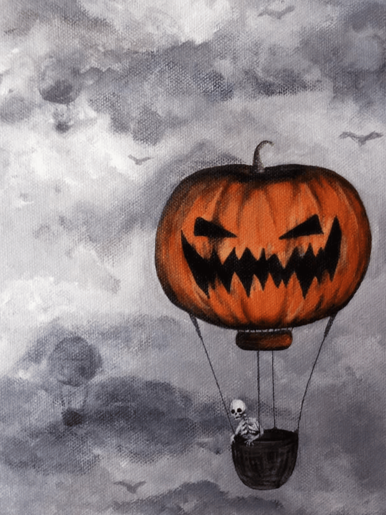 Pumpkin balloon floating through Halloween fog