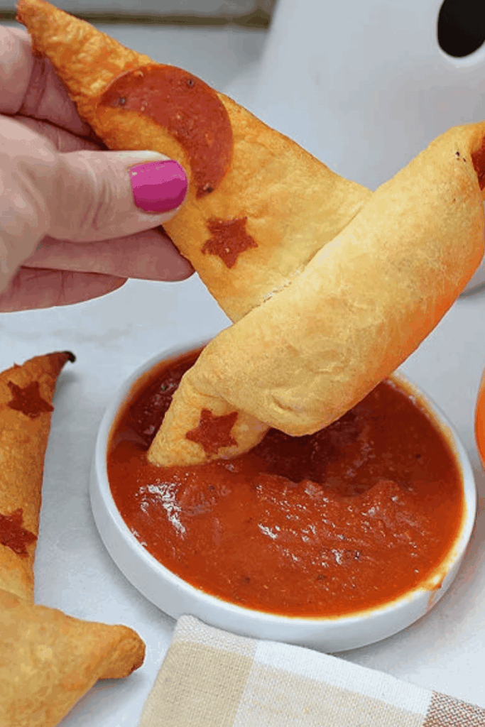 Crescent roll witch hat dippers served with barbecue sauce for party guests