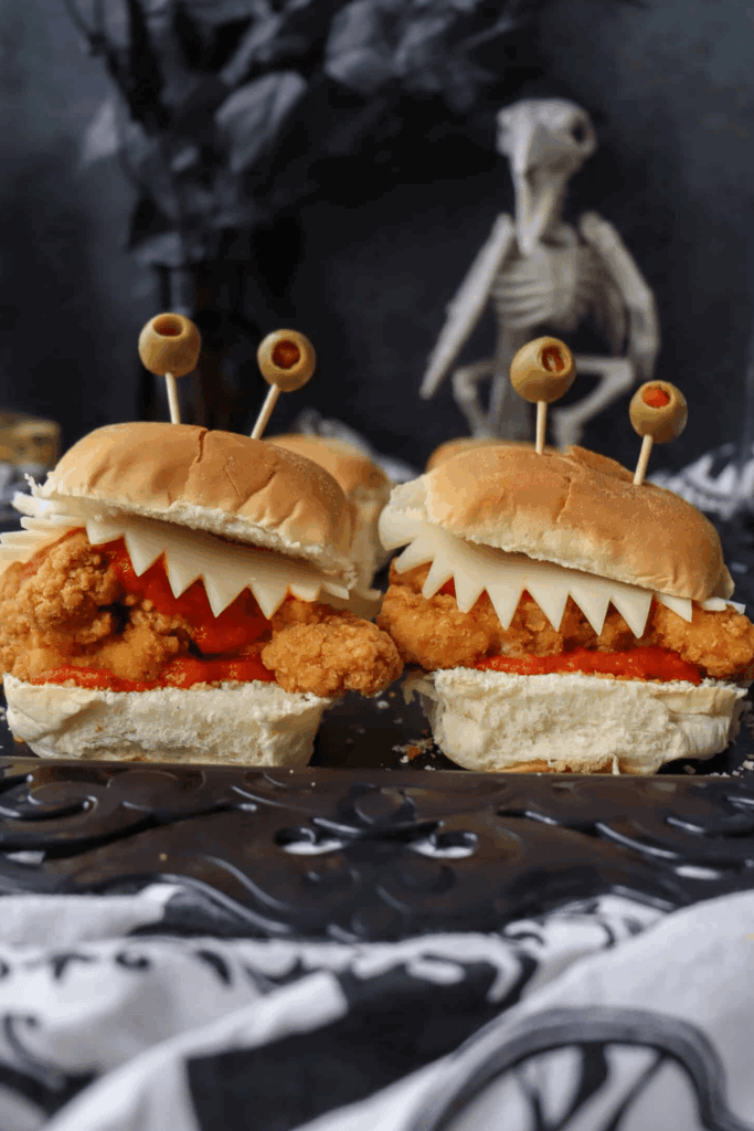 Monster sliders with cheese “teeth” and olive “eyes” – spooky finger foods
