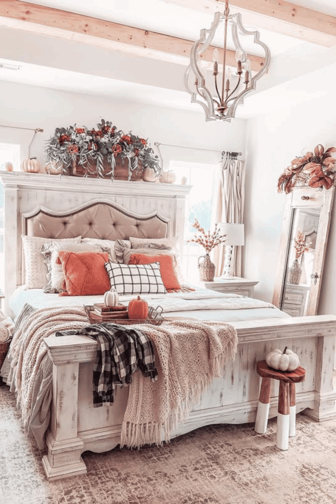 Master bedroom with pops of fall color through pillows and throws