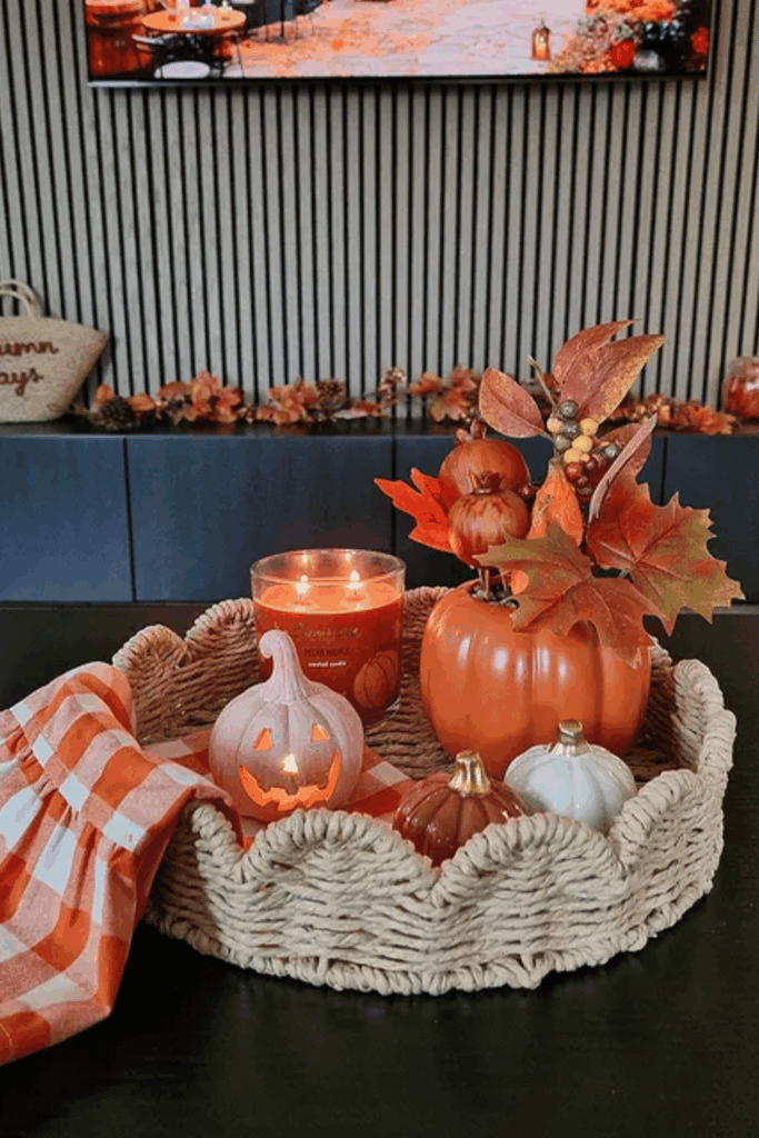 Coffee table tray styled with pumpkins, candles, and fall leaves