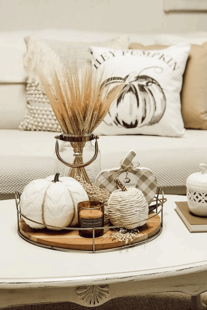 Wheat stems and faux pumpkins in different sizes as a simple centerpiece