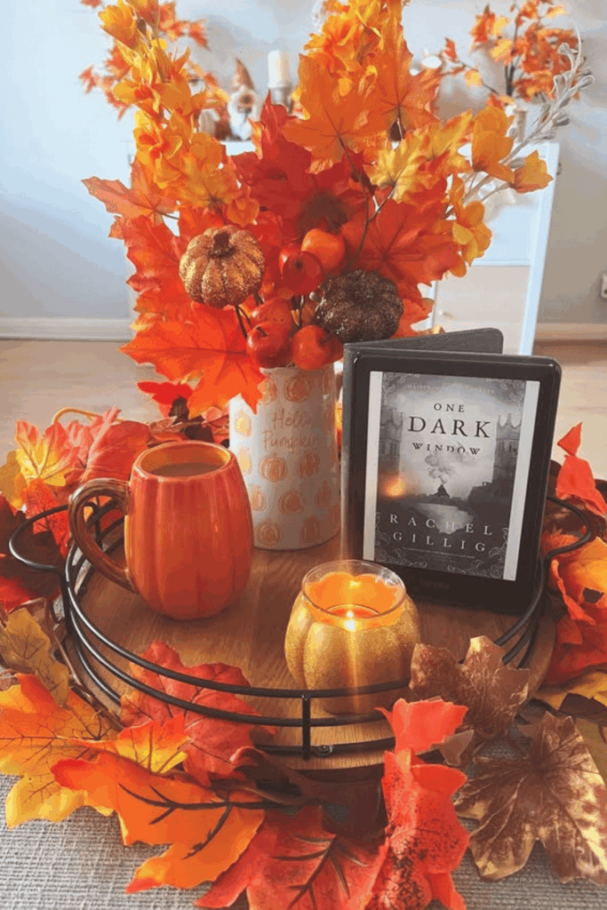 Large tray with fall leaves, mug, and coffee table book centerpiece