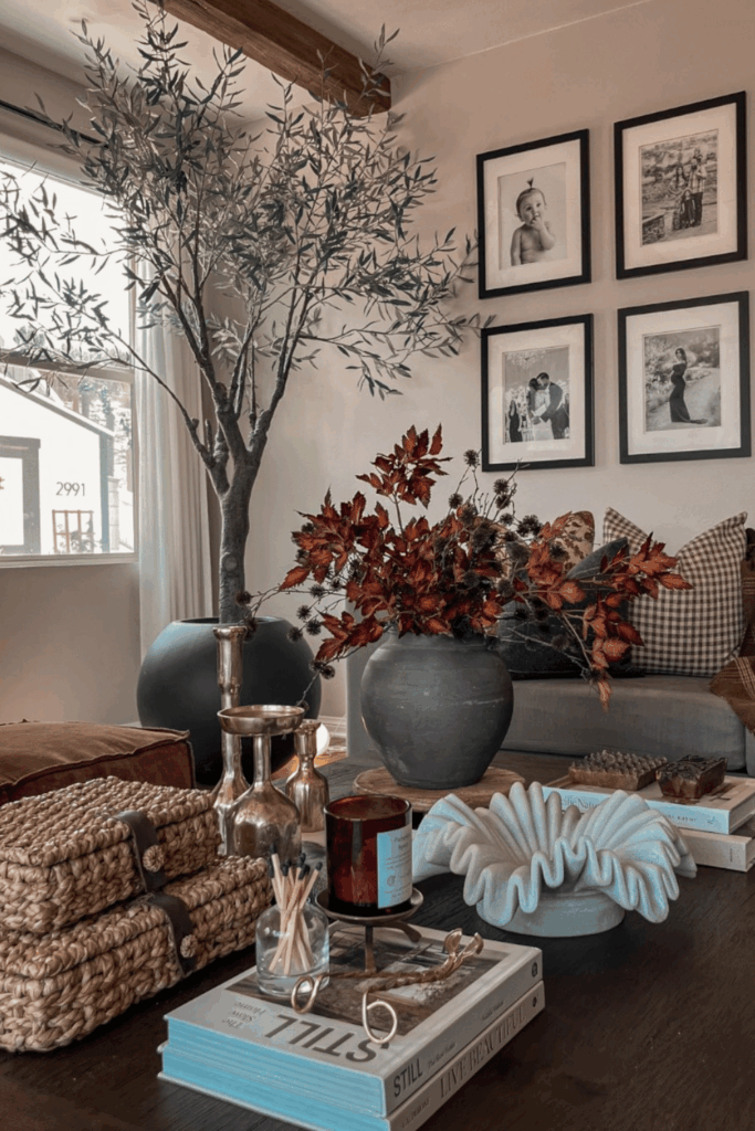 Coffee table styling with woven baskets, ceramic vase, and rich fall colors