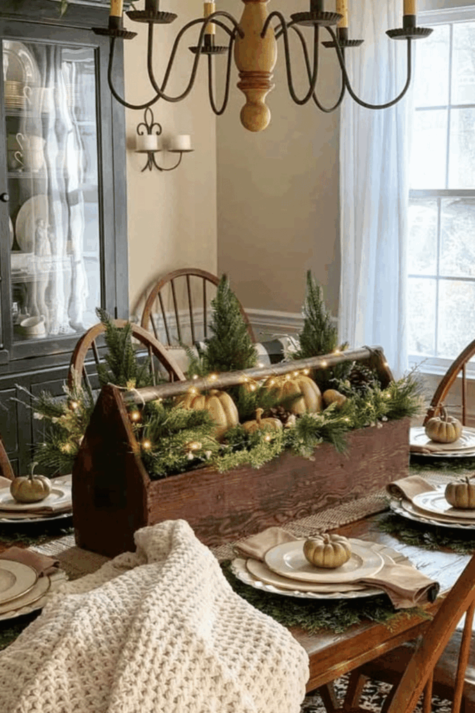 Rustic wooden caddy centerpiece with mini pumpkins and jars of flowers