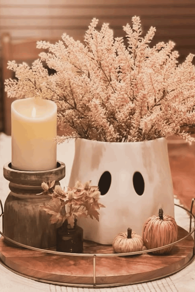 Ghost-shaped vase filled with flowers for a spooky fall table centerpiece