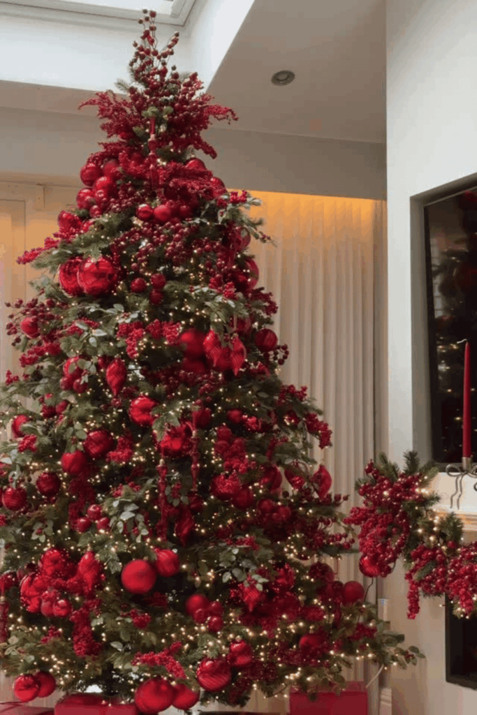 Red Christmas tree with deep red baubles and berry branches