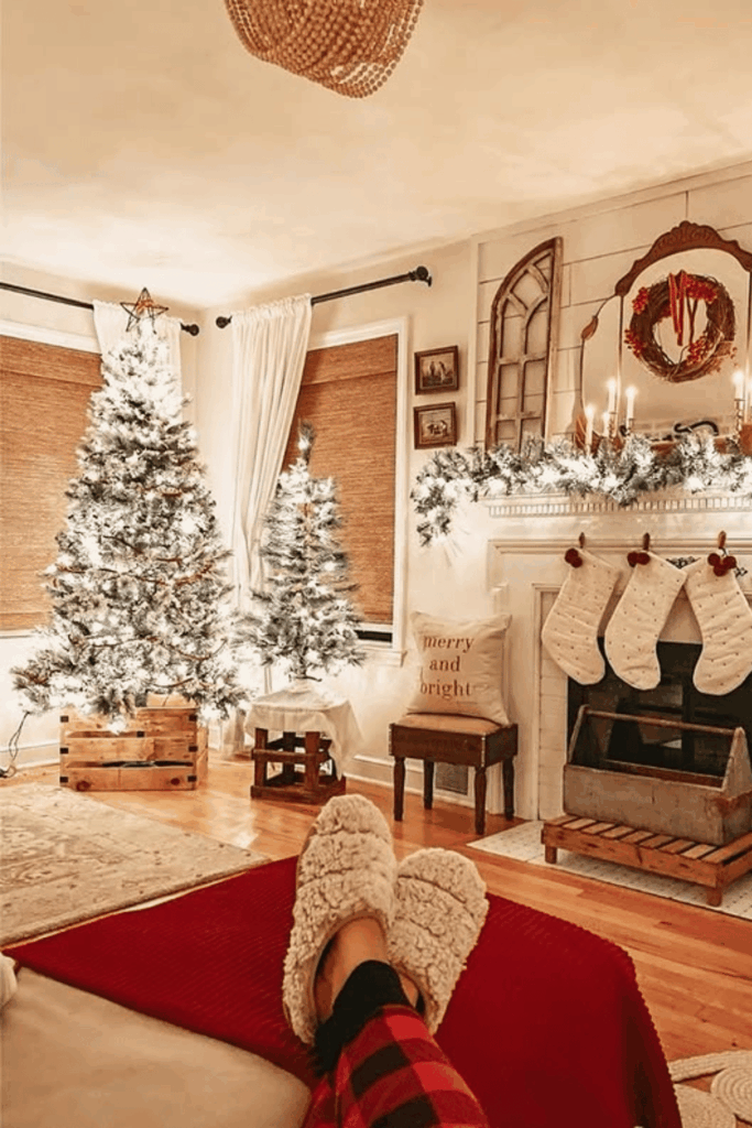 Cozy living room with flocked Christmas trees and glowing mantel garland