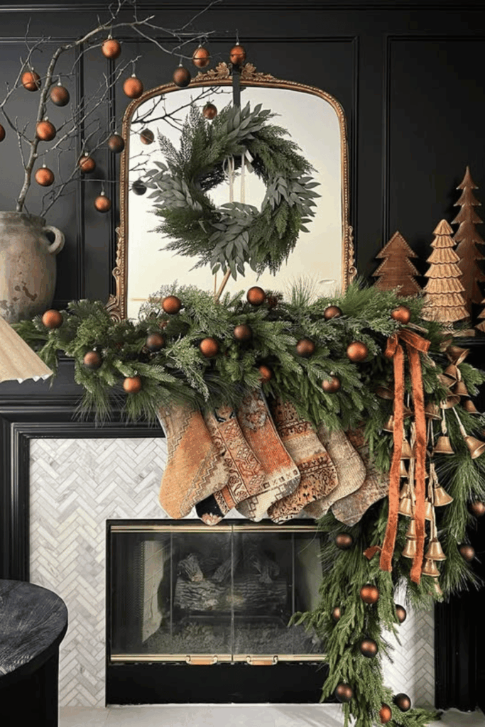 Dark moody mantel decorated with oversized garland, stockings, and wreath