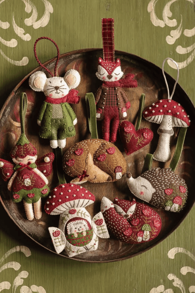 Woodland-themed felt ornaments including fox, mouse, mushrooms, and hedgehogs