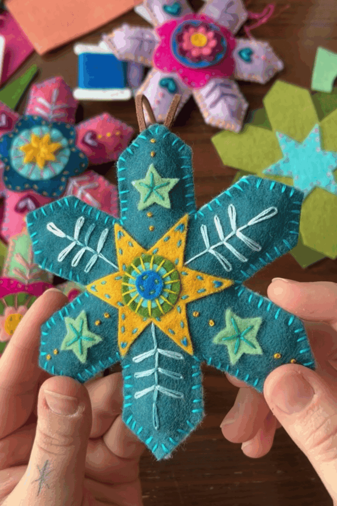 Bright layered felt snowflake ornament with embroidered details