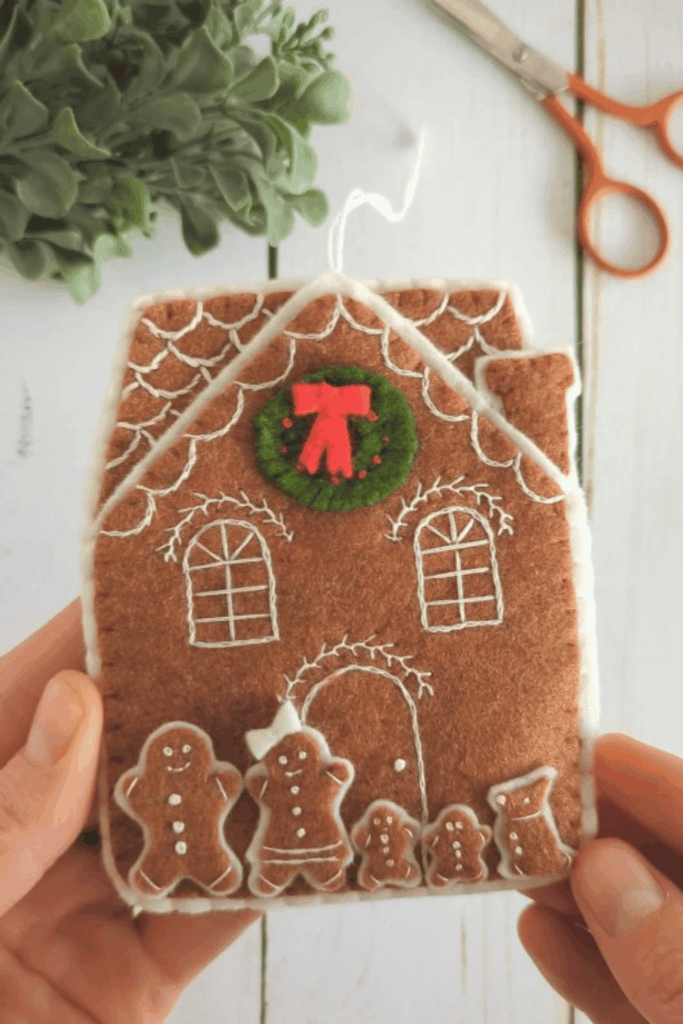 Felt gingerbread house ornament with wreath and gingerbread family details