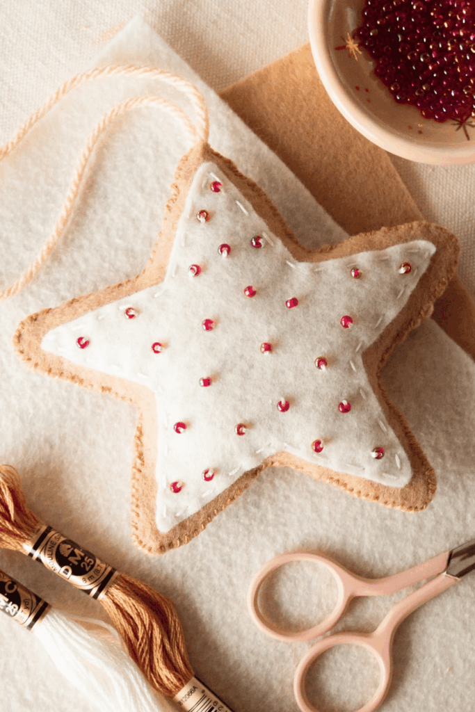 White felt star ornament embellished with small pink beads