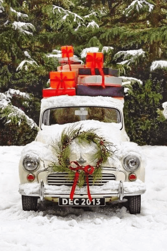 Festive car driveway display with gifts, greenery, and wreath