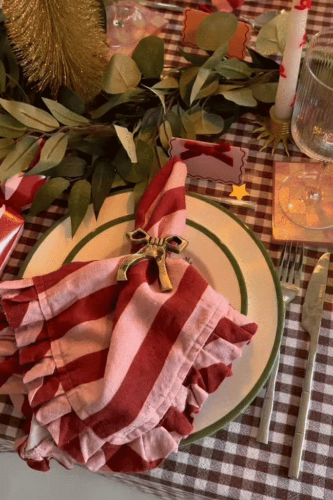 Christmas place setting with folded napkin and decorative table details