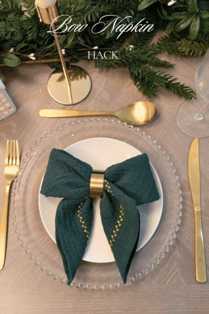 Christmas place setting with bow-folded napkin and gold flatware