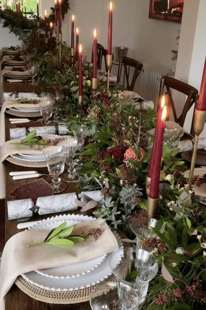 Elegant Christmas dining table with greenery and tall taper candles