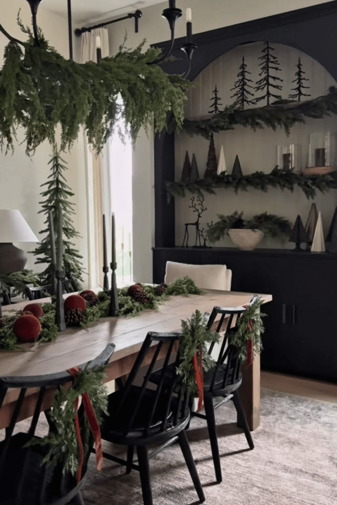 Christmas table centerpiece with hanging greenery and long floral arrangement