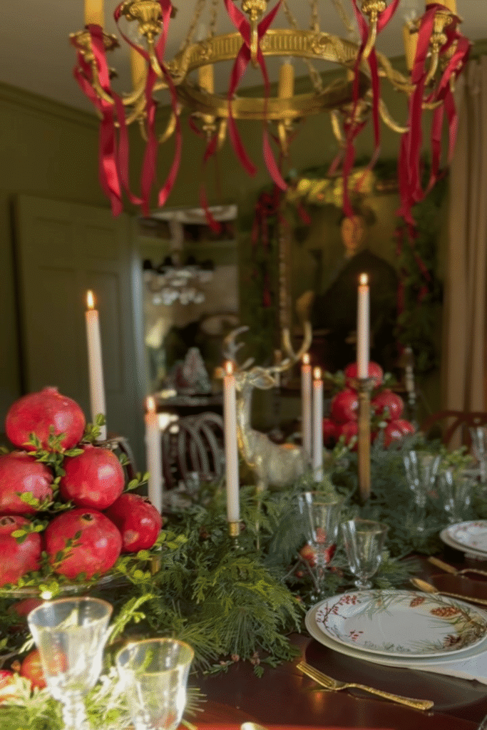 Holiday table centerpiece using seasonal fruit, greenery, and candle centerpiece
