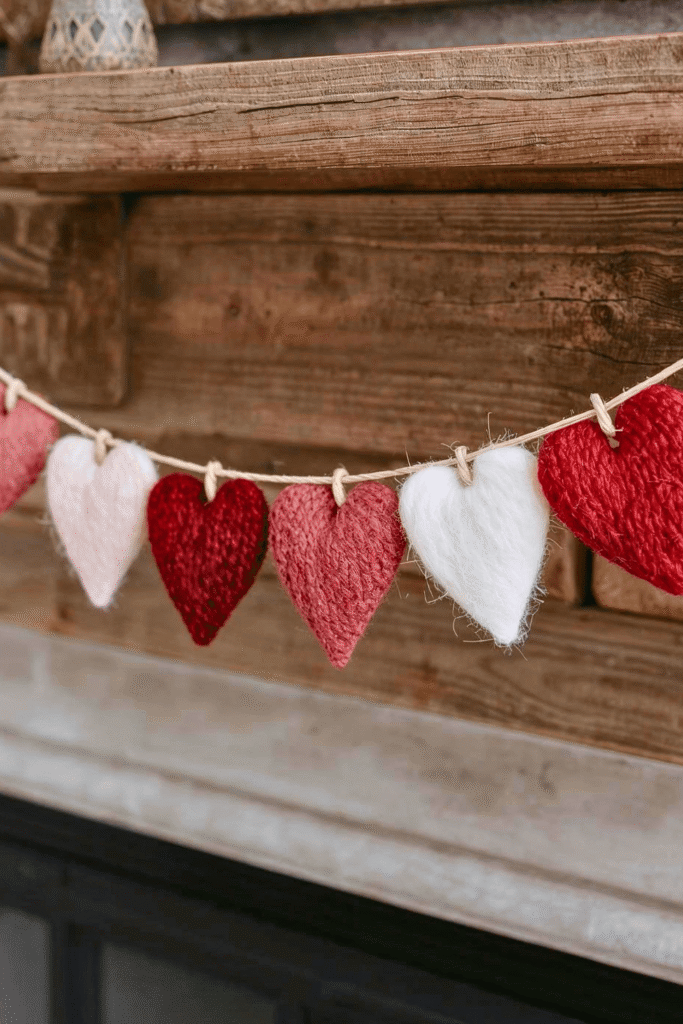 Felt heart garland hanging on a rustic mantel