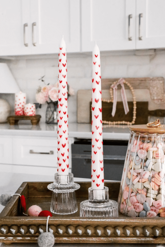 Valentine taper candles painted with small red hearts