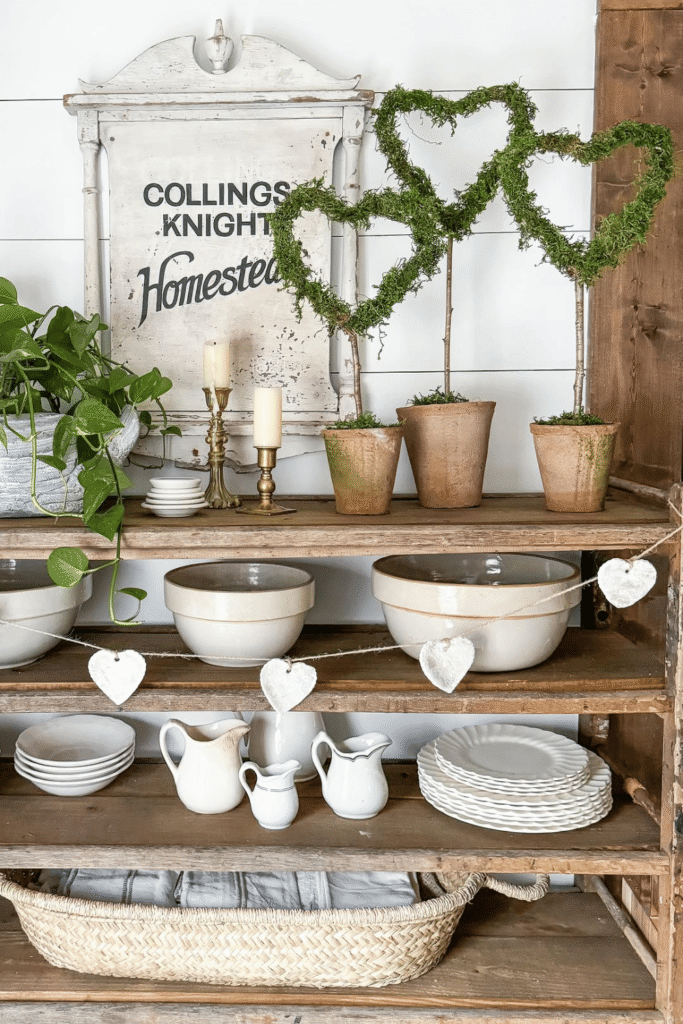 Valentine’s Day shelf decor with heart-shaped topiary plants