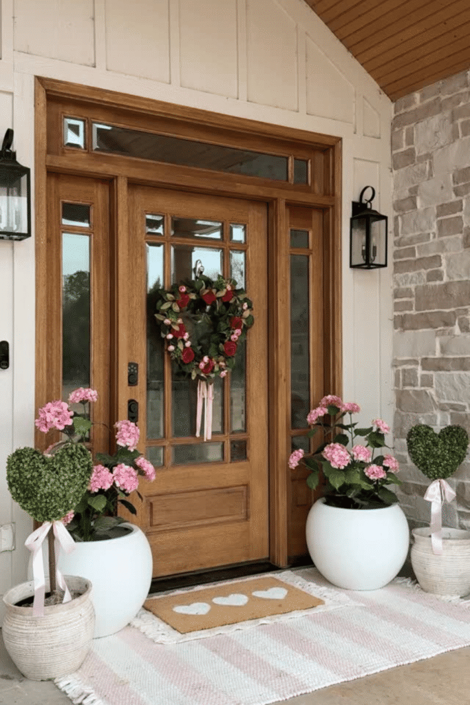 Front porch Valentine’s Day decor with heart wreath and potted plants