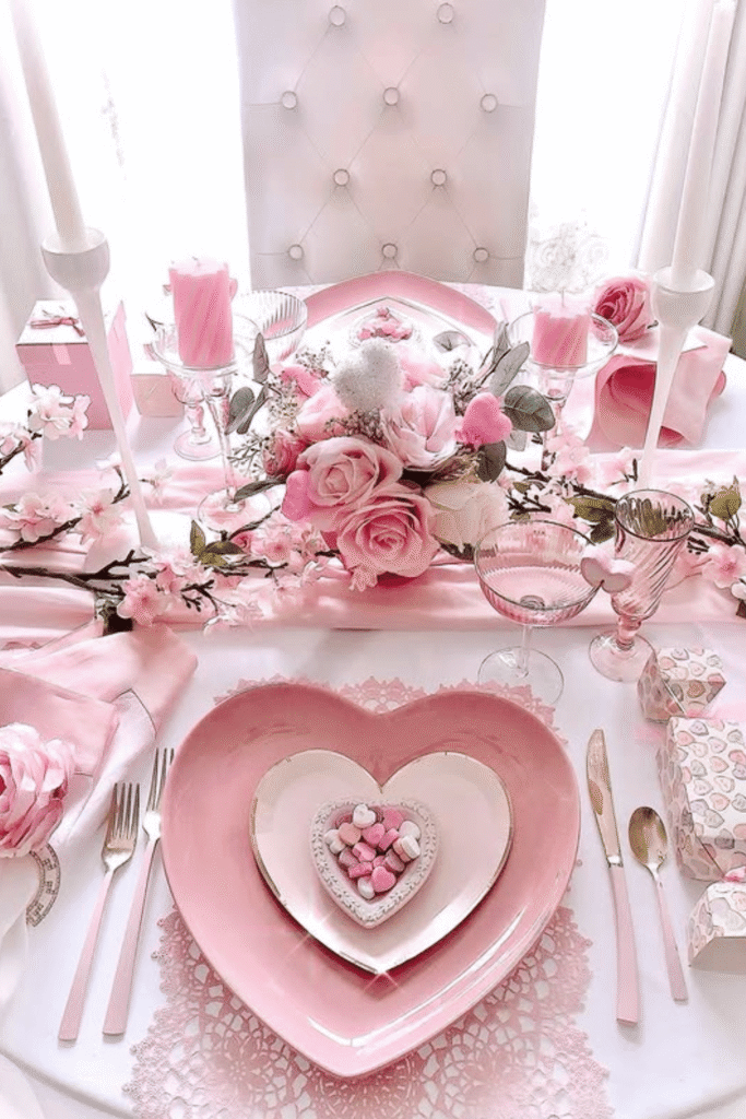 Pink Valentine’s table with layered heart-shaped plates and floral centerpiece